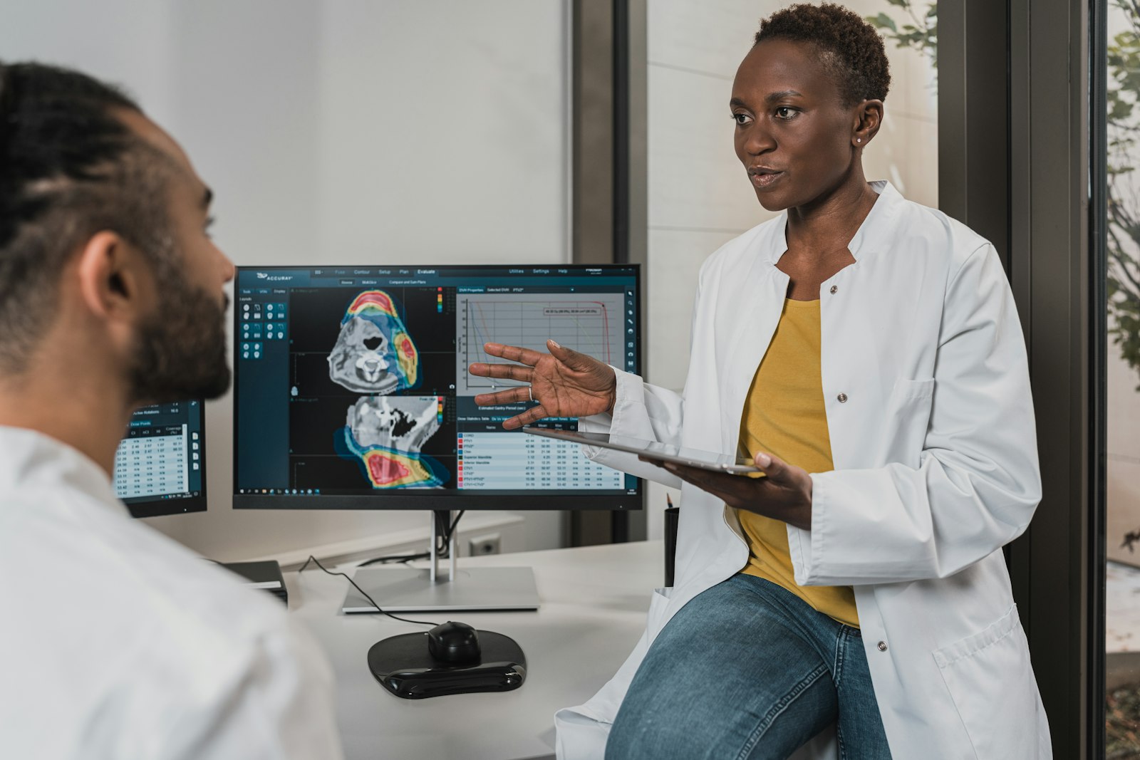 Clinicians reviewing imaging on screens